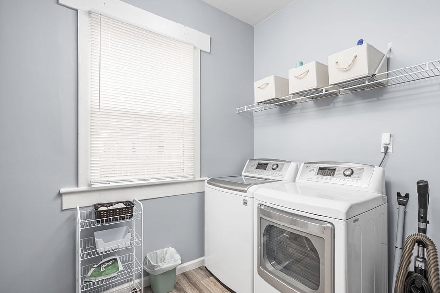 Bright and organized laundry room with modern appliances and ample storage.