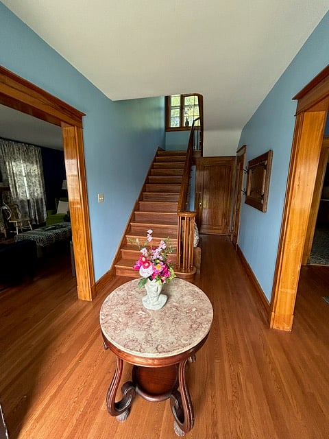 Enjoy a "Downton Abby" like entrance into your home-away-from-home when you step inside and find a floral bust on a beautiful, antique pink marble top table in the foyer.