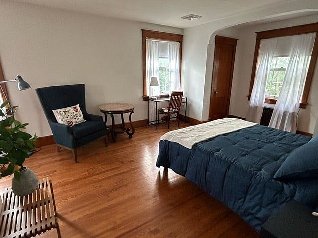 Unit 1 includes queen size bed, oversized armchair, antique marble-top end table, cozy desk, three lamps, four windows, three closets (one a cedar closet),full-length mirror, and a full bathroom (shower/tub combo).
In addition, Unit 1 comes complete with two sets of bed sheets, two comforters, ample towels, hand towels, face towels, and two bath mats.