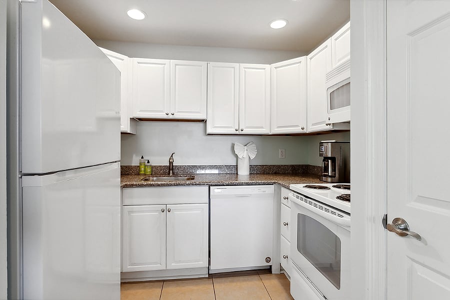 fully equipped kitchen with full-sized refrigerator, full-sized oven and electric range, microwave, and dishwasher