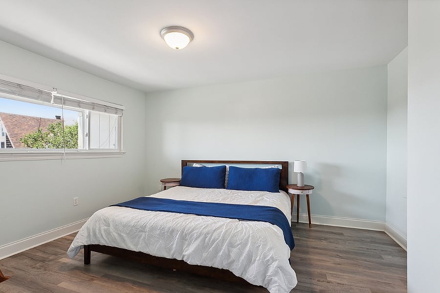 primary bedroom with en suite bathroom and king bed