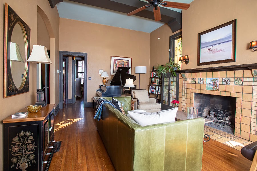 Living room with 11' ceilings, craftsman fireplace, and baby grand piano.