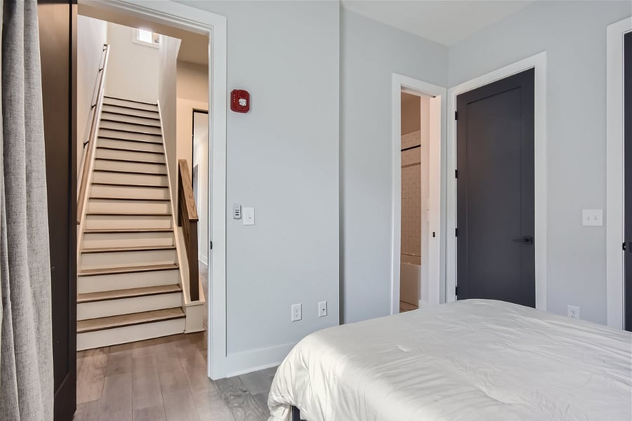 The bedroom sits on the 2nd floor of the building, which is the 1st floor of the apartment. Living room, kitchen, full bathroom, and balcony are upstairs.
