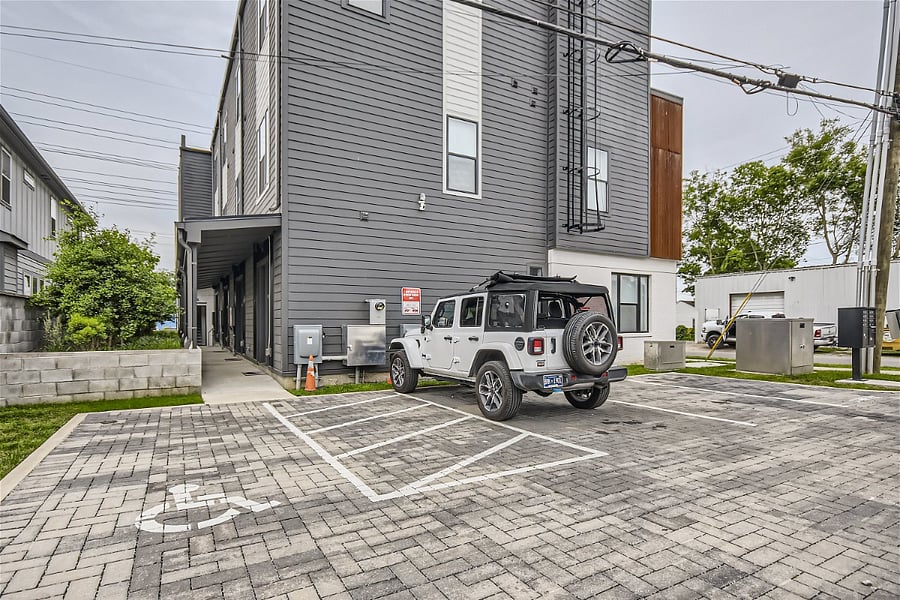 This 10-space parking lot right behind the building is reserved for residents and 1-hour retail only. There is always plenty of space. Exterior entrance to the unit is at the end of the walkway pictured.