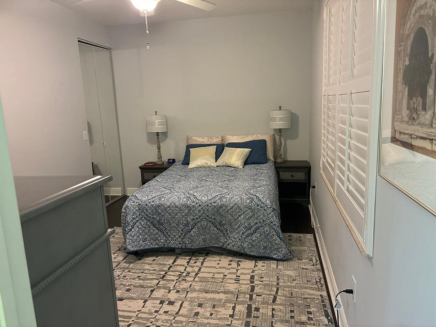 Bedroom with Sleep Number bed, walk-in closet, smart TV. Small desk optional.