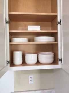 Full kitchen of kitchenware all stowed behind cabinet doors