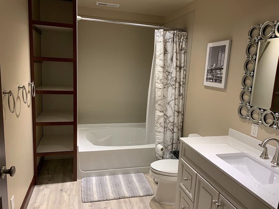 Full bath with tub, shower and four separate cubbies, drawers and towel rings