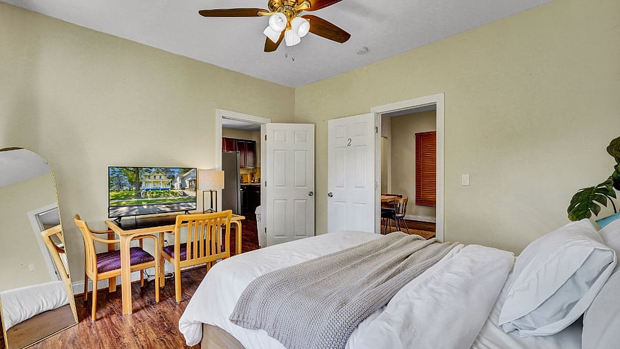 **Bedroom 2**: Features Working Desk, And Smart TV.
