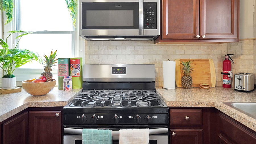 Stainless Steel Microwave, Gas Stove, Fire Extinguisher.