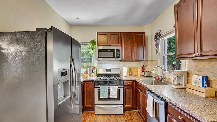 **Kitchen**: New Stainless Steel Fridge, Dishwasher, Coffee Station, Cups, Plates, Cooking Utensils.