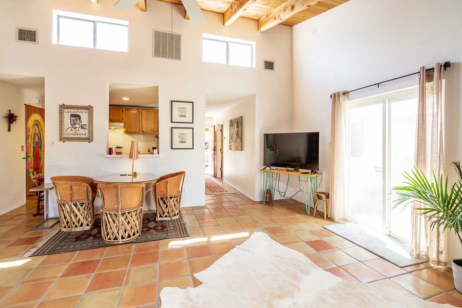 Living room has pitched ceiling with windows, lots of light