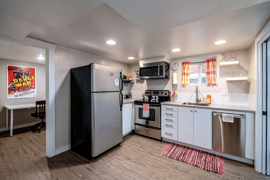 Wide-angle view of kitchen with office doorway to the left.