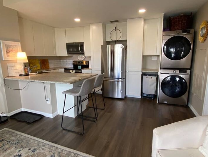 Kitchen view with stackable washer and dryer.
