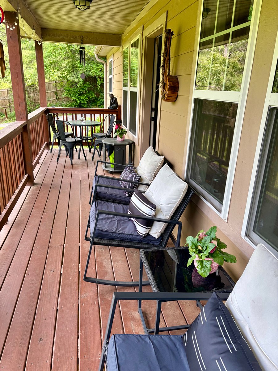 Beautiful west-facing deck with a small dining table and wind chimes.