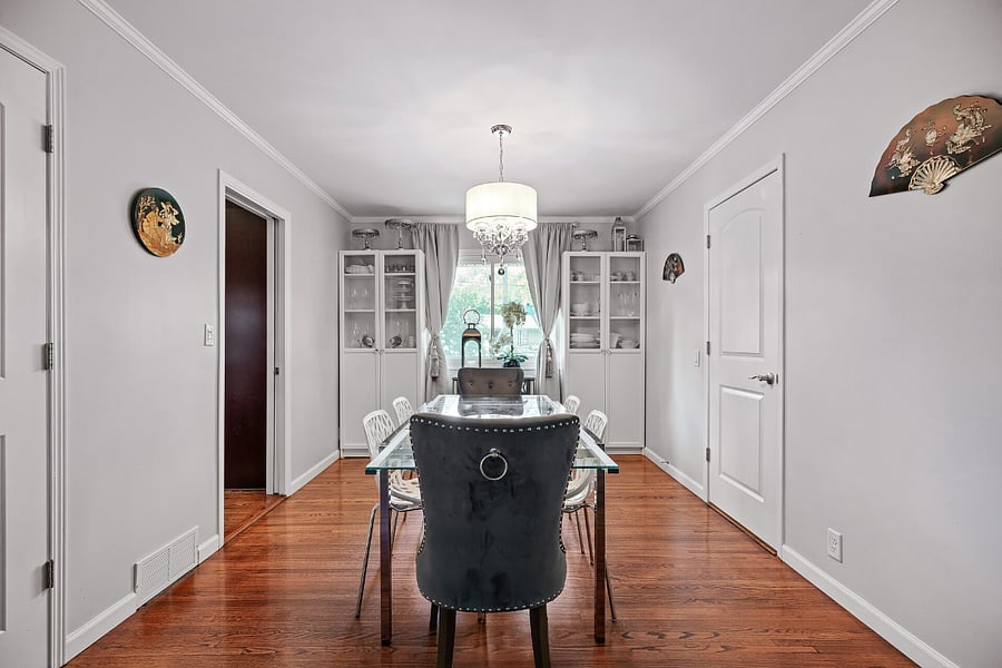 Dining space has 2 large cabinets stocked for a party: china, glass, platters, etc.