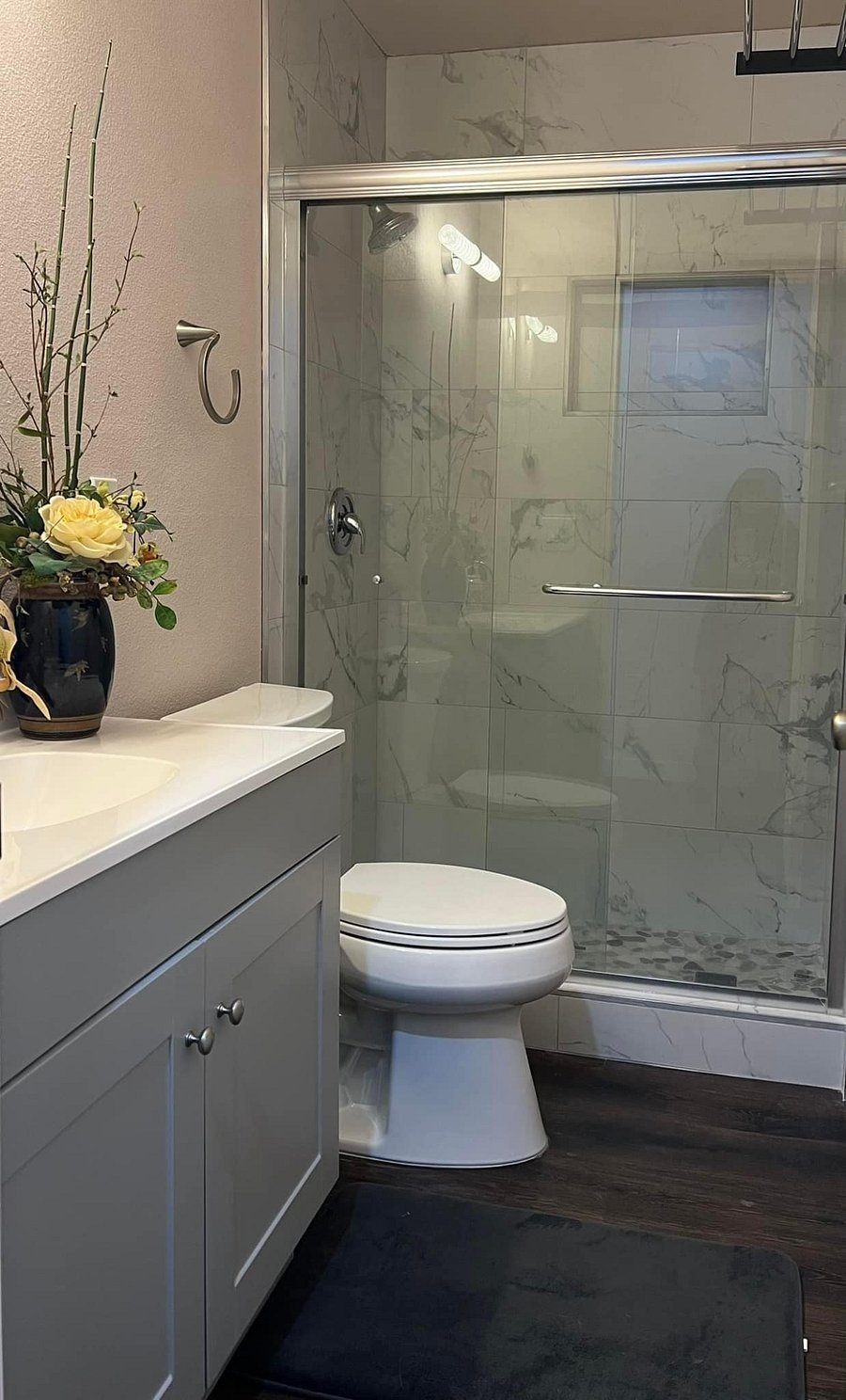Bathroom with standing rain shower, and in shelf storage.