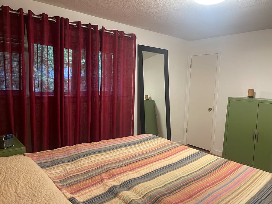 King bed in primary bedroom. Large mirror. Dresser. Large closet with barn type door. And extra door to bathroom if desired to use that path.