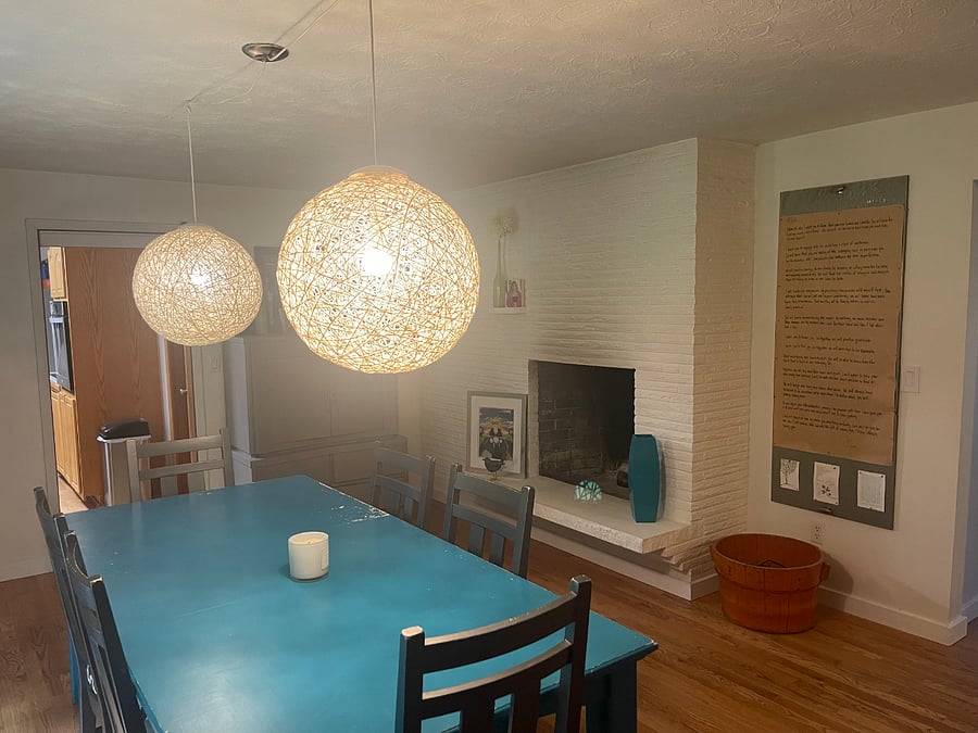 Large dining room with large dining room table and chairs and a fireplace.