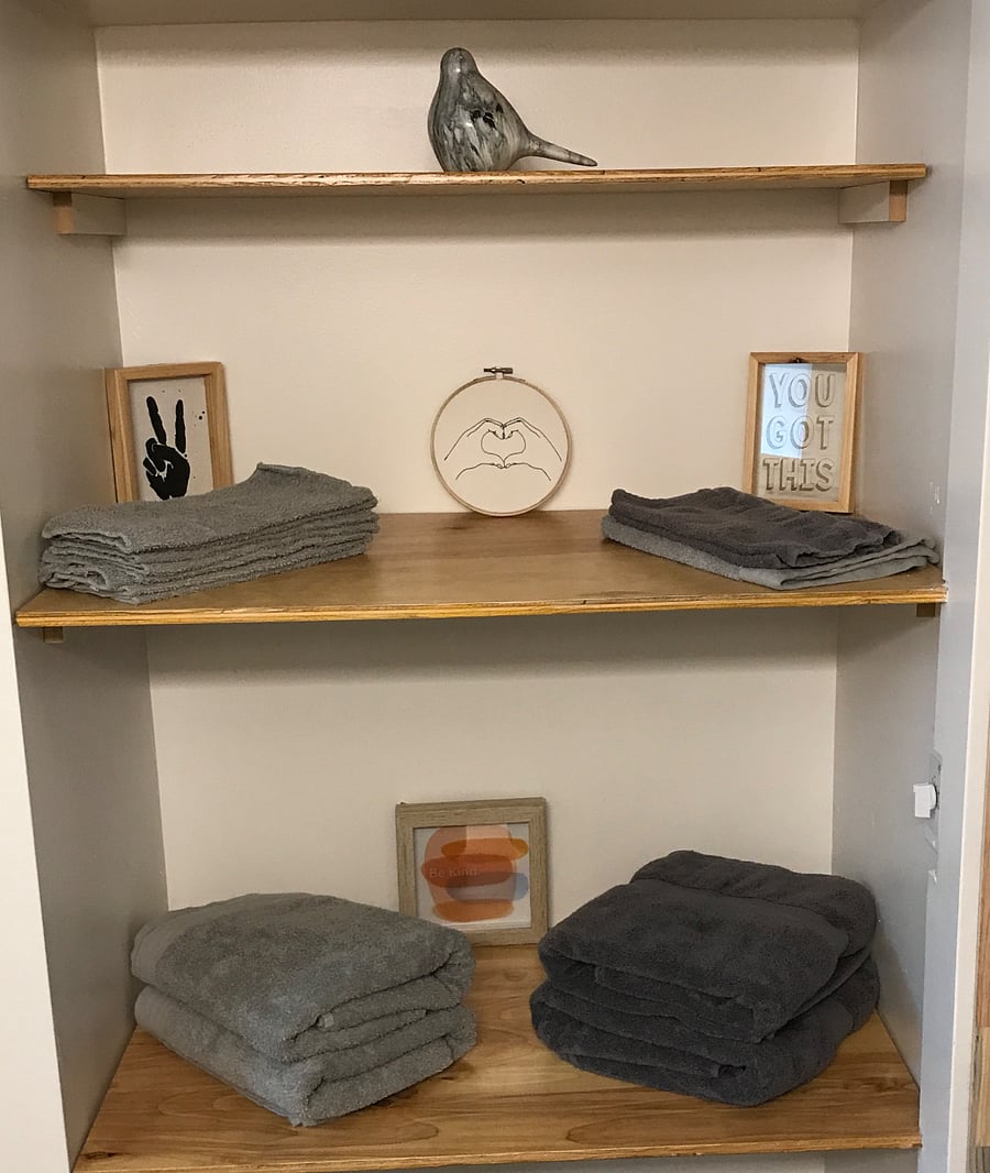 Open linen closet in bathroom