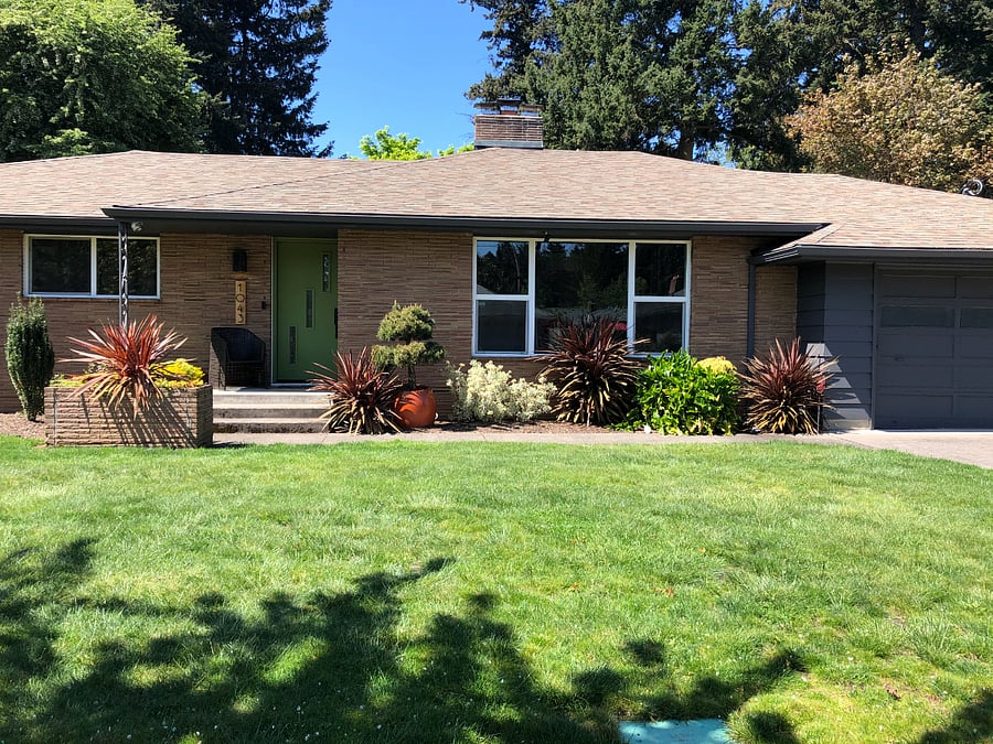 Exterior of home. Main Level entry.  Entry to the apartment is to the right of garage.