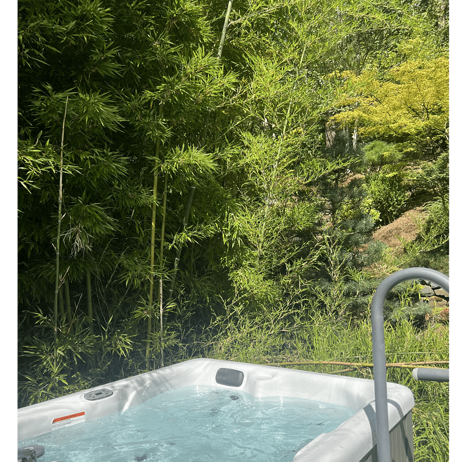 Hot tub surrounded by garden views.