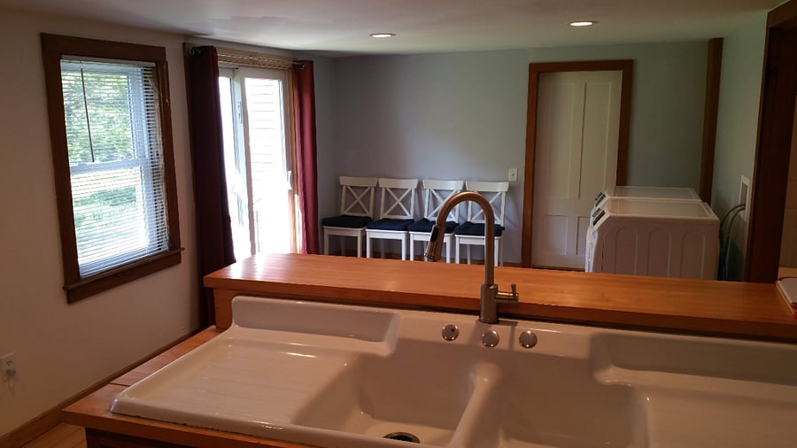 Original porcelain farmer's sink with new faucet.