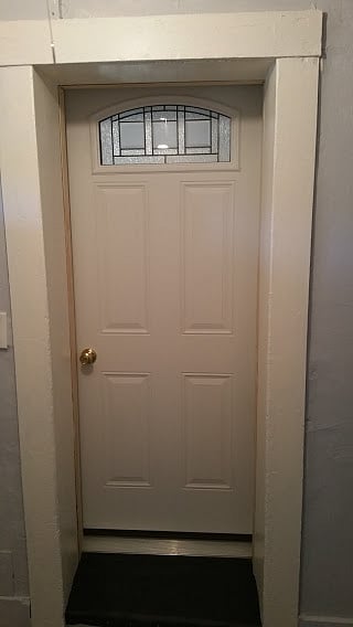 Inside entrance to unit with small mudroom space with closet.