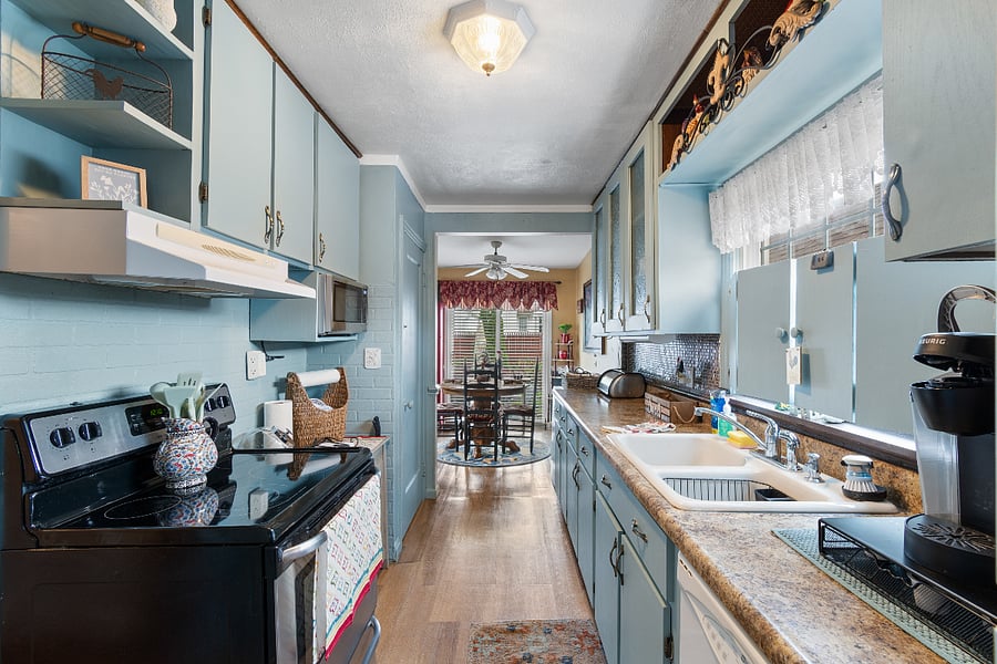 Fully furnished kitchen with dishwasher leads to second dining or office area