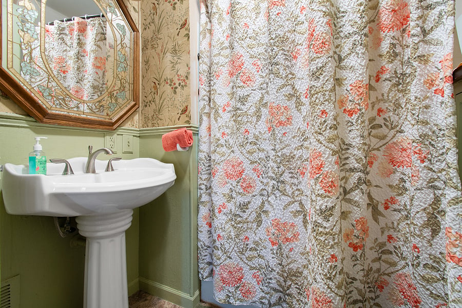 Bathroom with shower and plenty of storage cabinetry