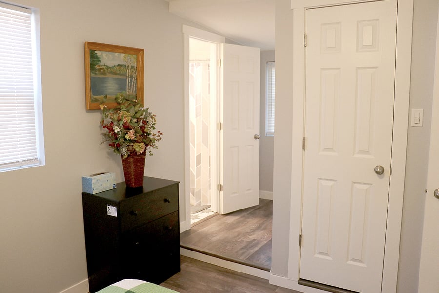 Master bedroom en suite with Queen size bed, full size closet with ironing board and iron, access to your own private bath and the basement laundry
