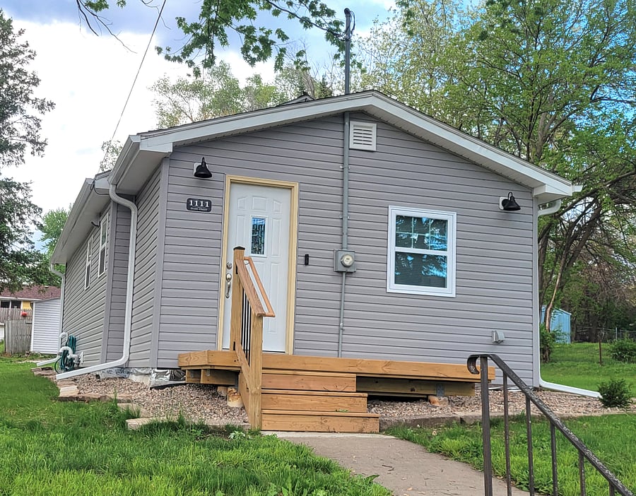 Cute front porch on slight hill above the road helps with privacy