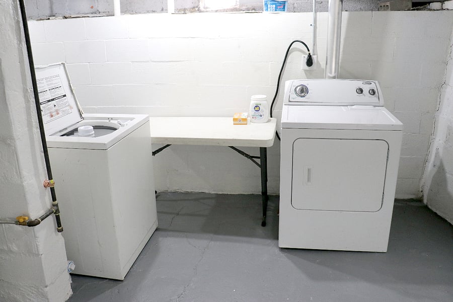Basement laundry includes full size washer and dryer