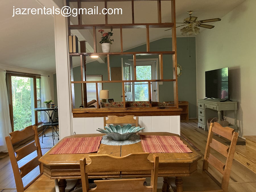 Eat-in kitchen overlooks living room and all the windows. Antique 70's wood table set from an aunt!