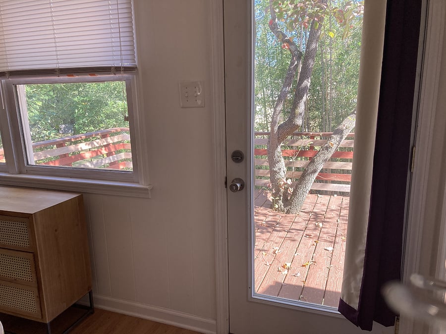 Glass door & windows overlooking the back deck.