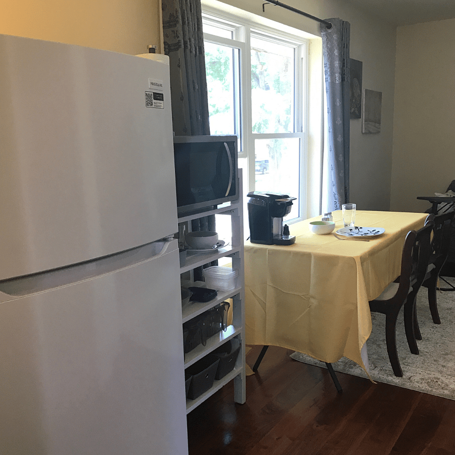 Fridge, microwave and large dining table