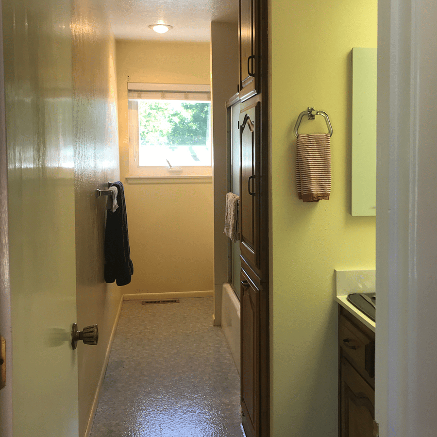 Long bathroom, lots of storage in vanity and cabinets.