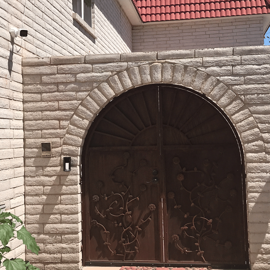 Tall walls and locked gates provide security and privacy from foot traffic. Window at top of frame is the bedroom window.