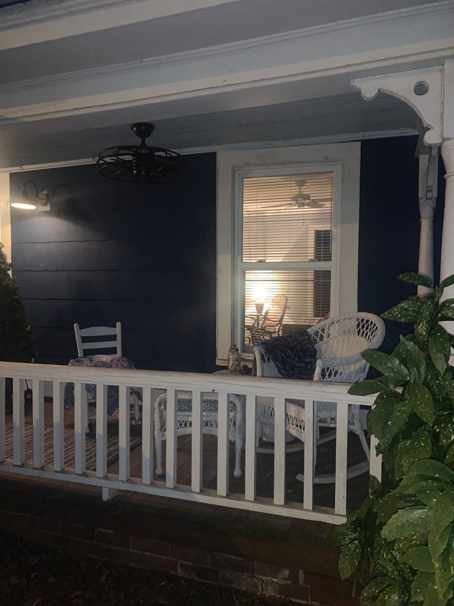 Front porch outdoor living space with ceiling fan