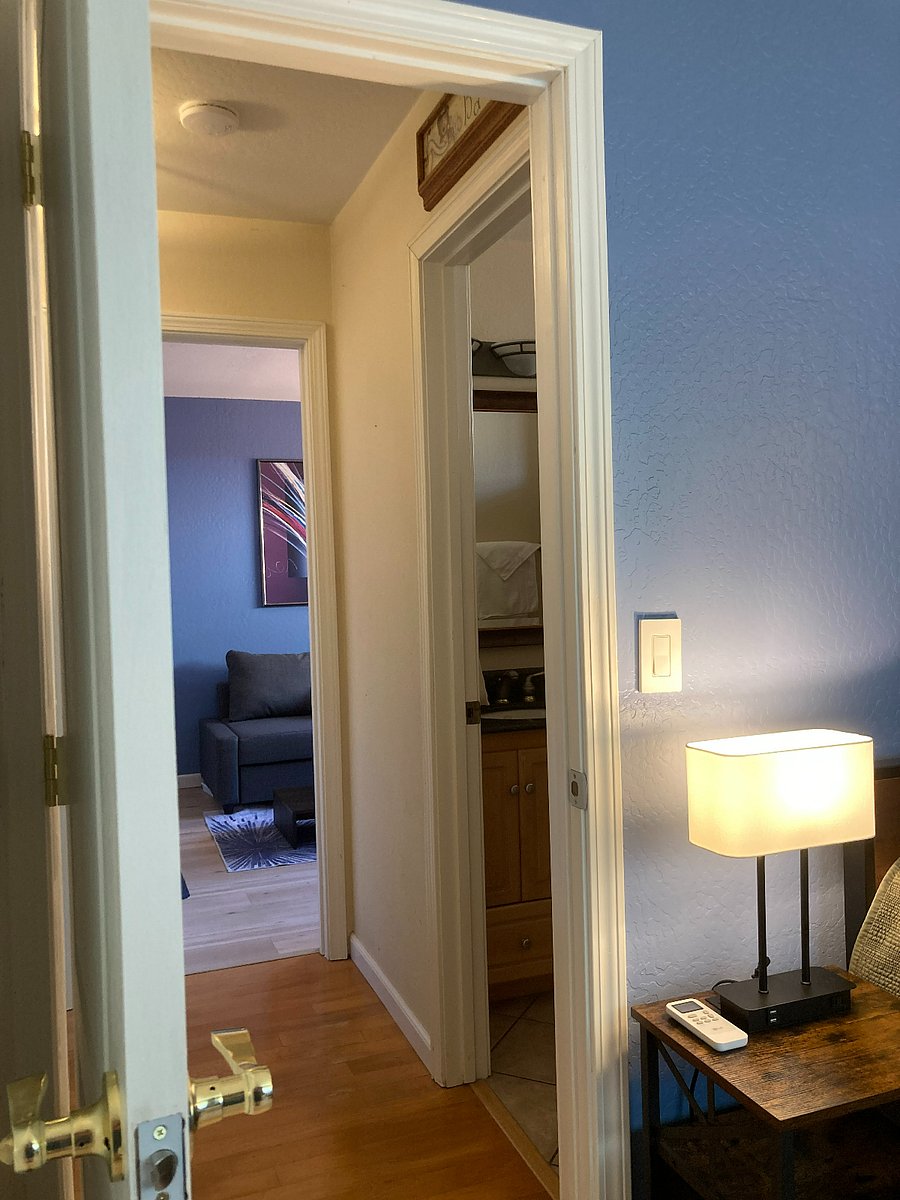 View from your bedroom into hallway, bathroom on the right and living room straight ahead