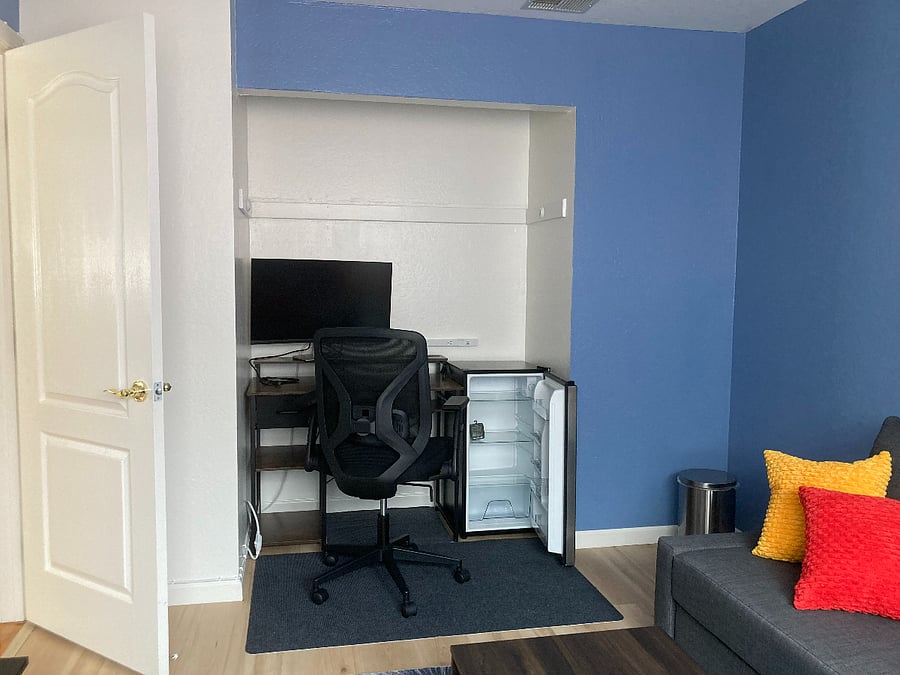 Your private living room with extra computer screen and small fridge (in addition to shared full size fridge in the kitchen)