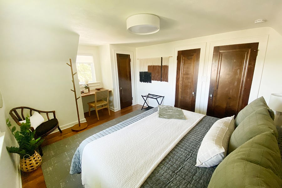 Light filled and cozy this bedroom can sleep three with foldout twin bed provided in closet. Designated work area in front of window.