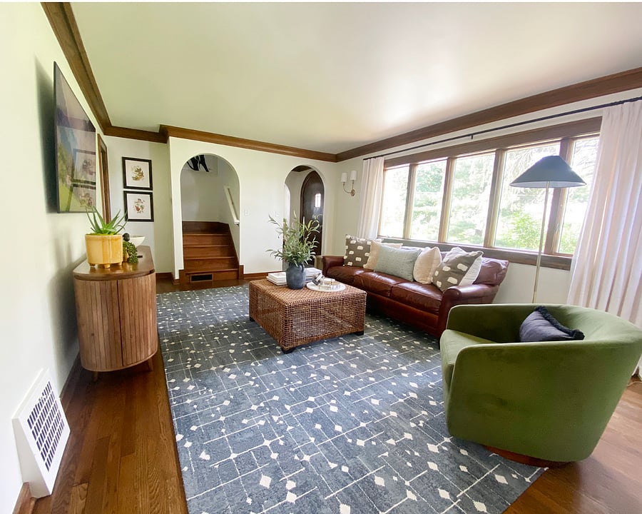 The staircase leads to two upstairs bedrooms and a full bathroom. The front door opens to a small, private front yard.