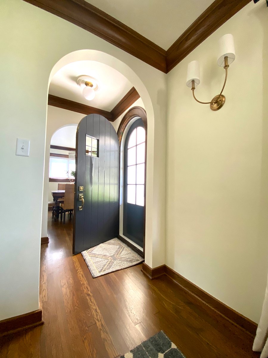 The front door opens to a serene, private front yard filled with beautiful trees, flowers and lush greenery.