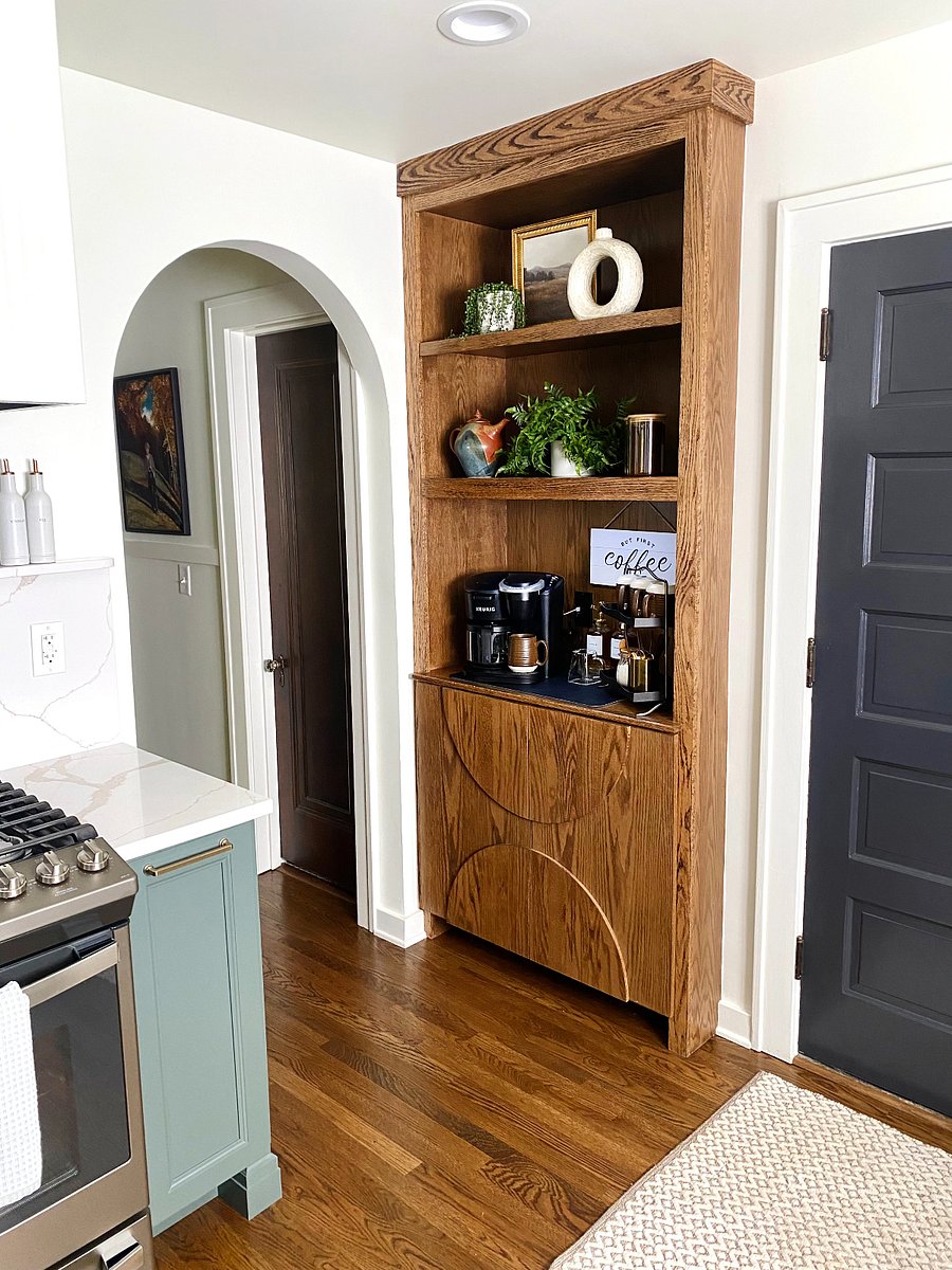 A custom-designed kitchen cabinet with a fully stocked coffee bar awaits, offering the perfect setup for your morning brew.