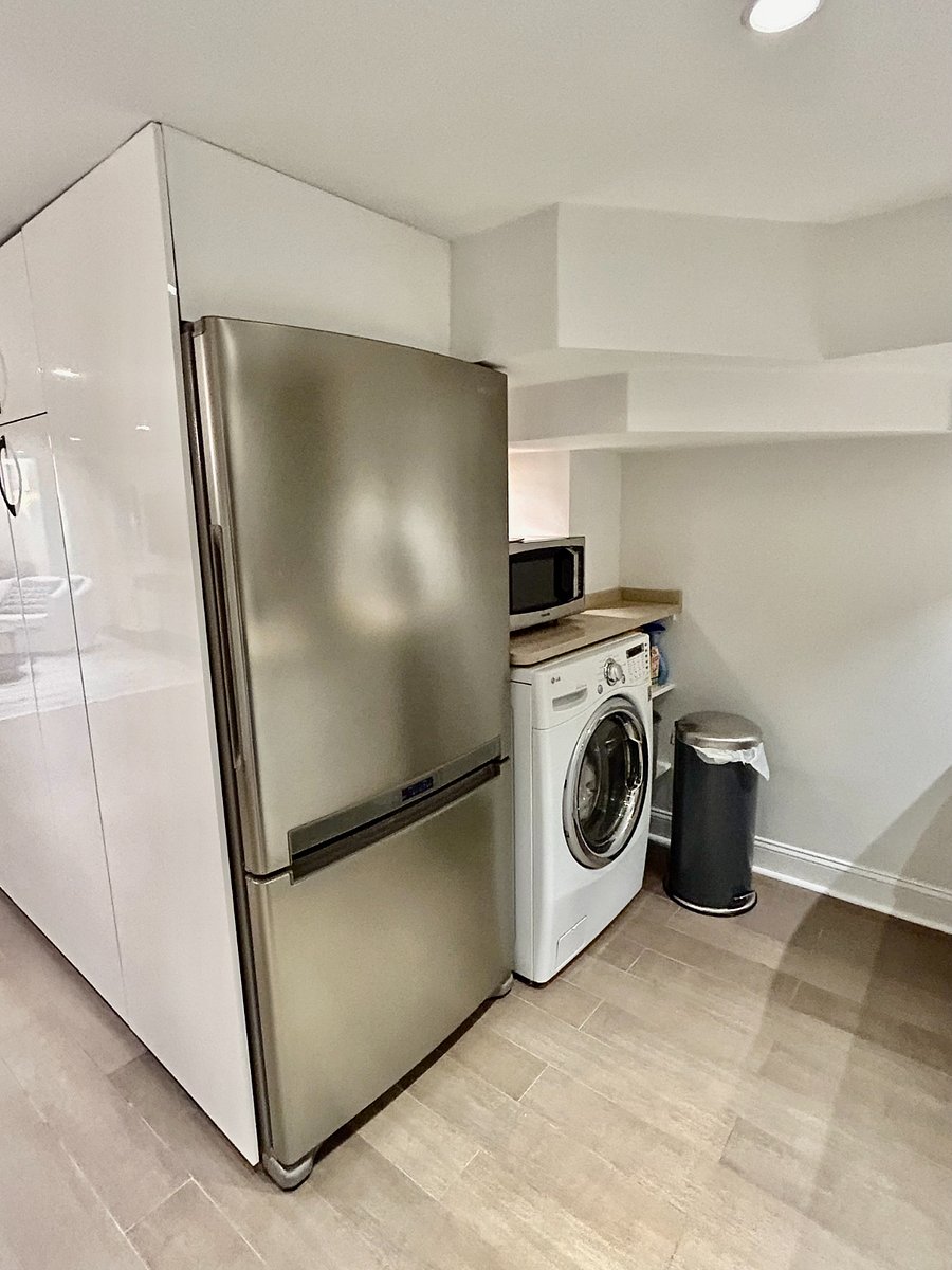 Full-sized refrigerator, microwave, and washer/dryer unit.