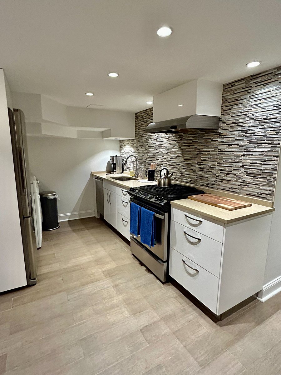Kitchen with gas range, sink, dishwasher, and coffee maker.