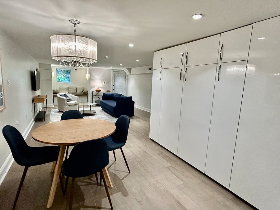 Dining area with floor-to-ceiling cabinets for storage.