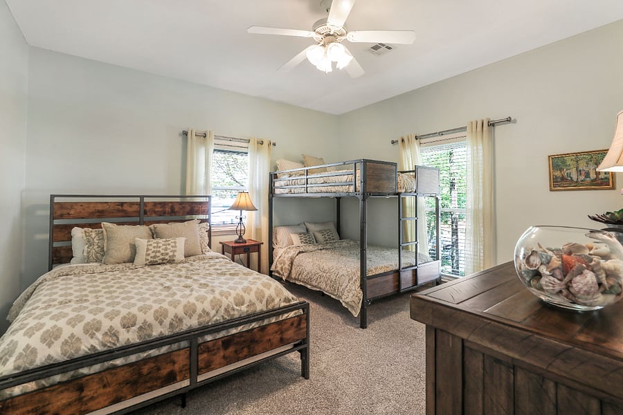 This is the second bedroom with a queen-sized bed and bunk beds.