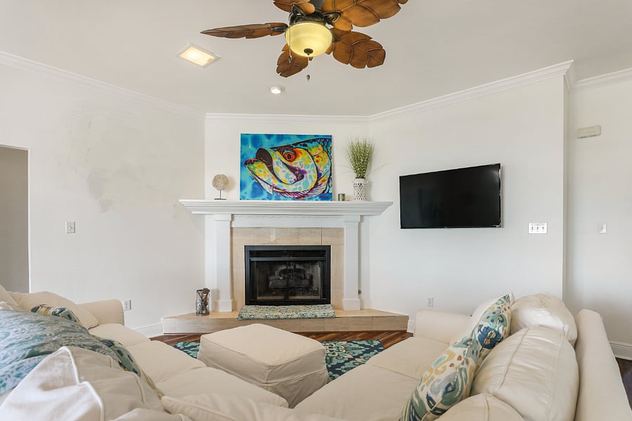 This is the living room as seen from the kitchen area with natural gas fireplace.