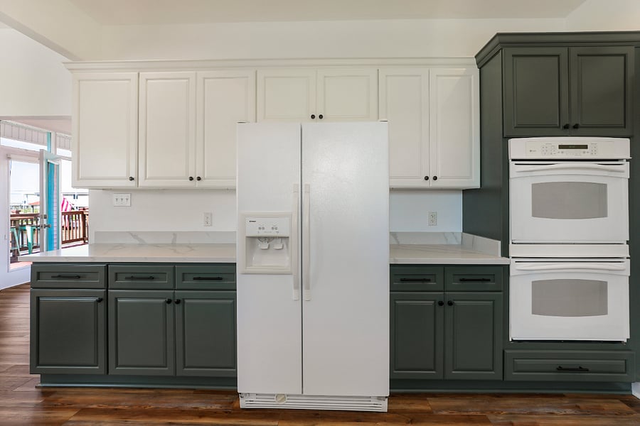 View of refrigerator and double oven.
